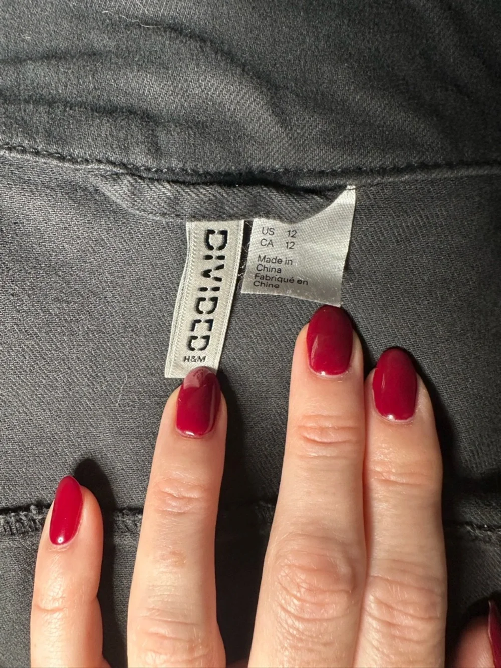 H&M DIVIDED Black Top with Deep Red Accent Nails in Frame